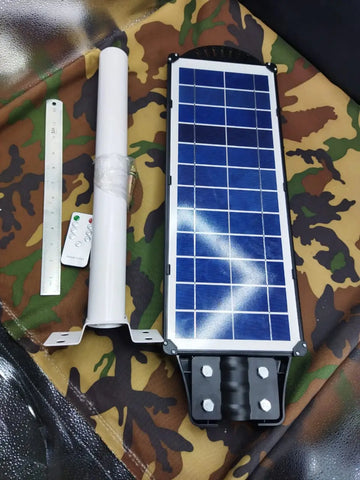 Solar street lamp with mounting pole, remote control, and scale for the Three Panel Solar Street Lamp