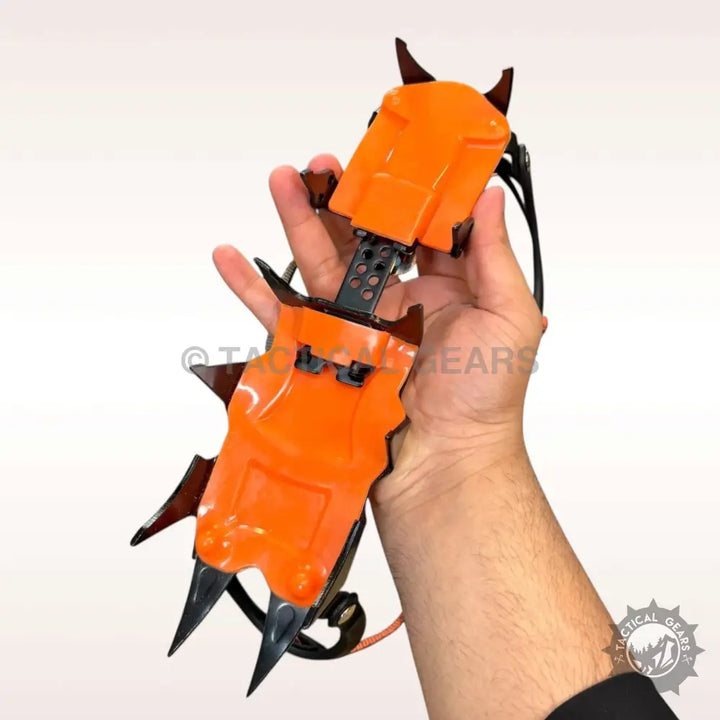 Orange and black tooth ice climbing crampons with sharp points for ice climbing adventures
