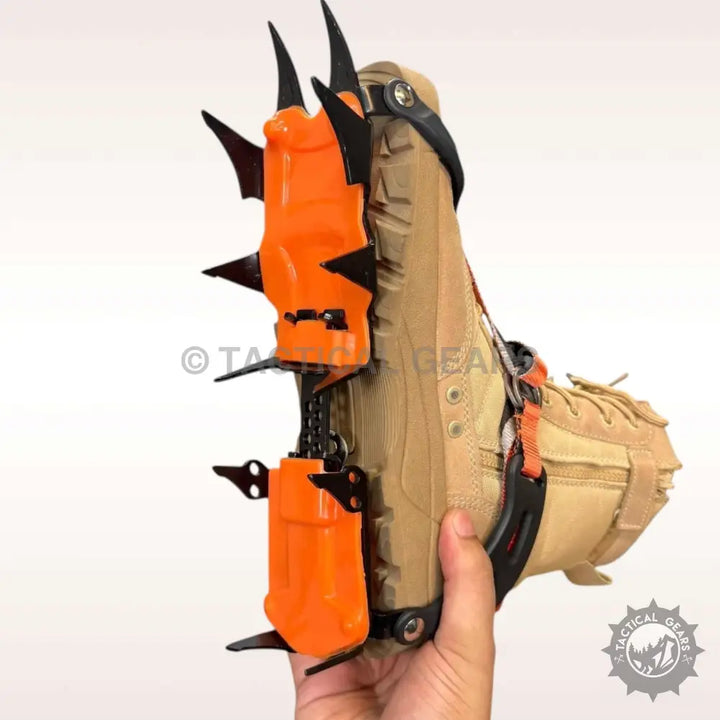 Tan hiking boot with orange and black tooth ice climbing crampons attached for ice climbing