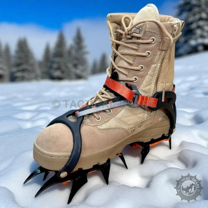 Tan combat boot with black and orange ice spikes on 12 Tooth Ice Climbing Crampons