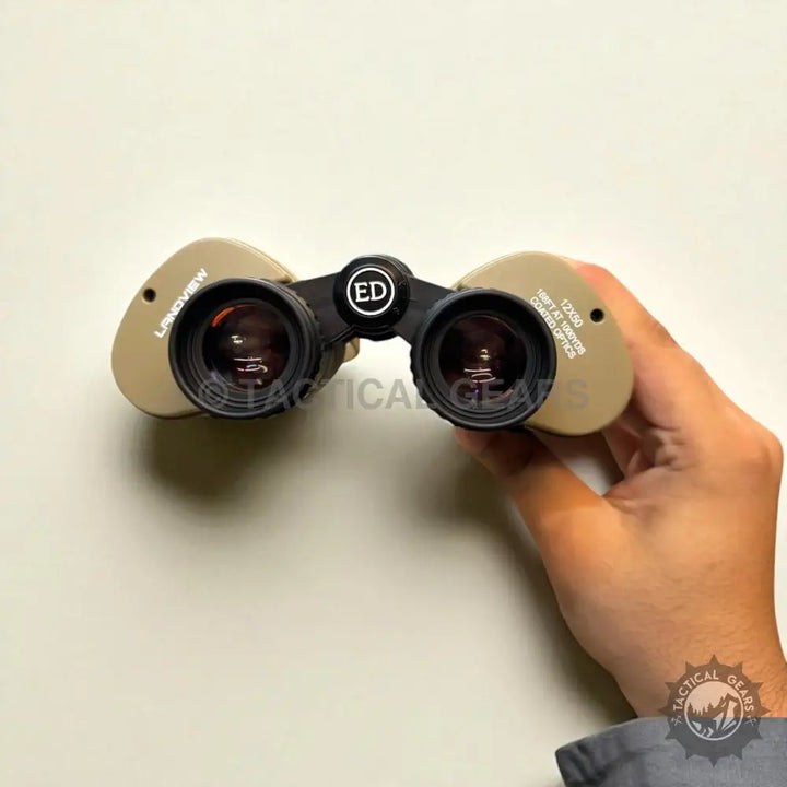 Tan-colored ED binoculars with black accents and green lens for clear outdoor viewing