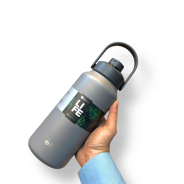Gray 1300ml thermal hot vacuum bottle with handle held by hand