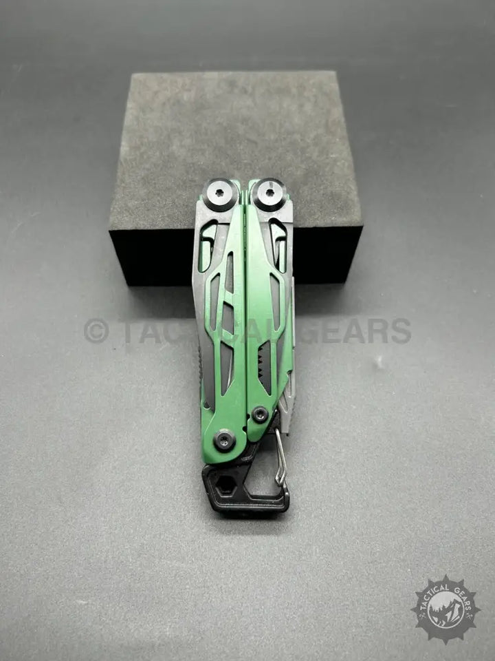 Green and silver stainless steel multi-tool with carabiner clip and bit set for outdoor use