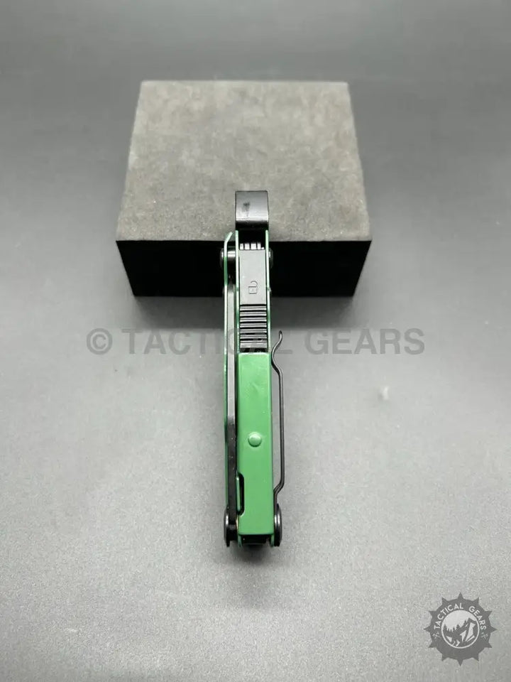 Green and silver stainless steel multi-tool with pocket clip and 14-in-1 bit set