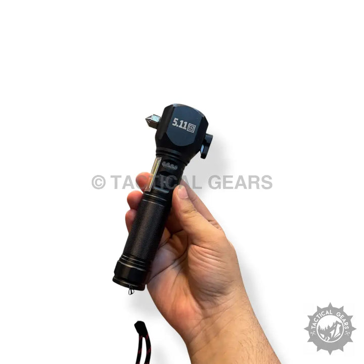 Black tactical multi-tool flashlight with textured grip and glass breaker for emergency use