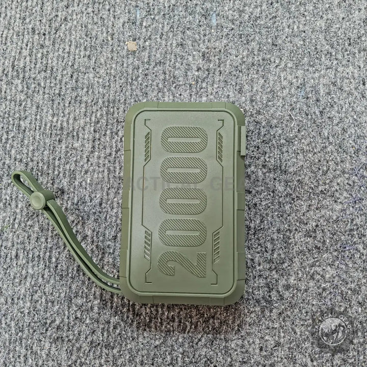 Olive green rugged power bank with wrist strap for reliable charging on the go