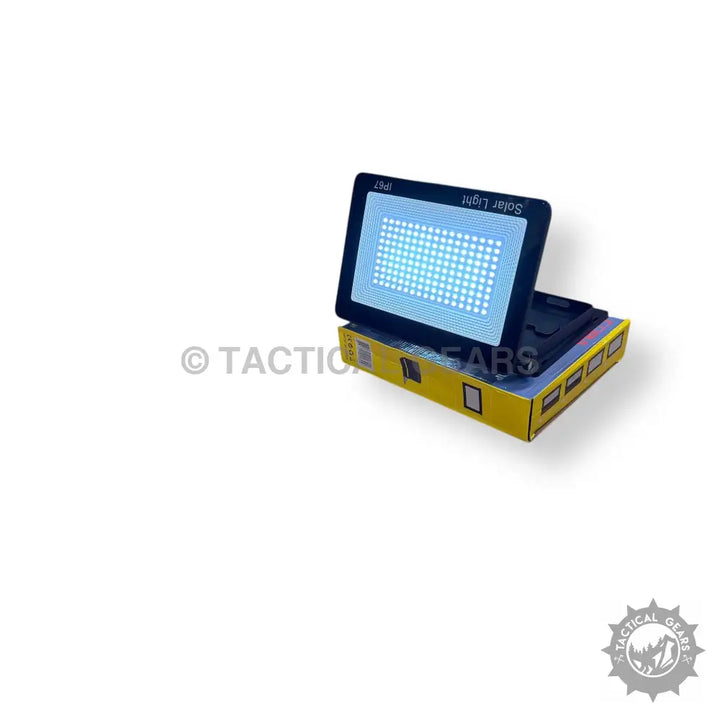 Black solar-powered LED floodlight with bright blue lights on yellow solar charging wall box
