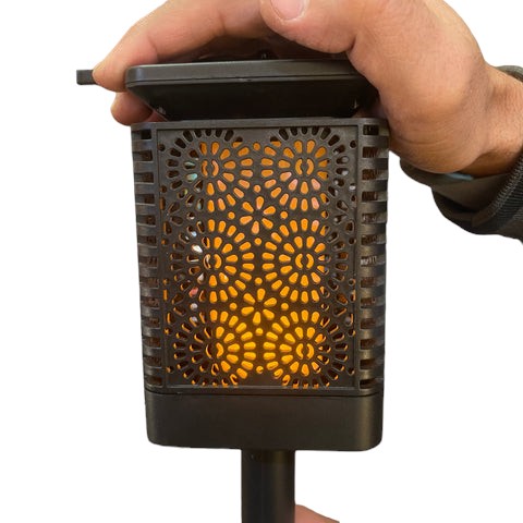 Solar outdoor garden light with flickering flame and decorative cut-out lantern design