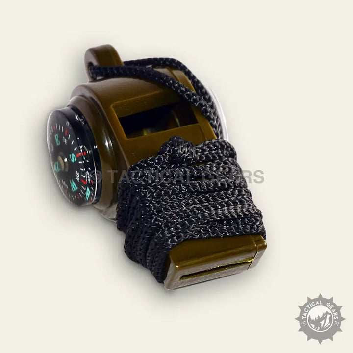 Olive green plastic survival whistle with integrated compass and black paracord lanyard