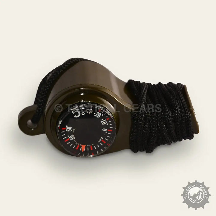 Olive-green outdoor whistle with integrated compass and thermometer for survival camping