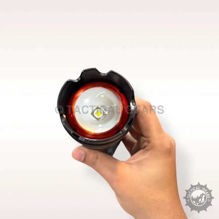 Hand holding 5000 Lumens White Laser Flashlight with bright LED and red-orange bezel