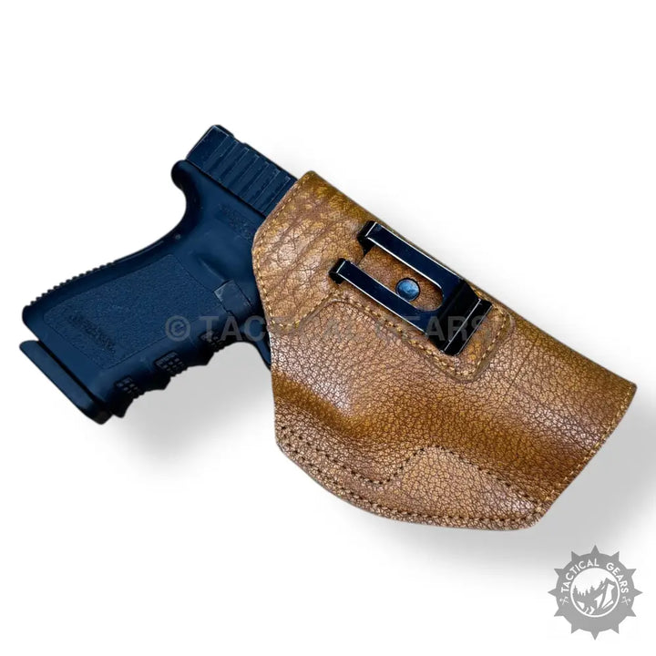 Easy to carry 9MM premium leather brown holster with a black handgun and belt clip
