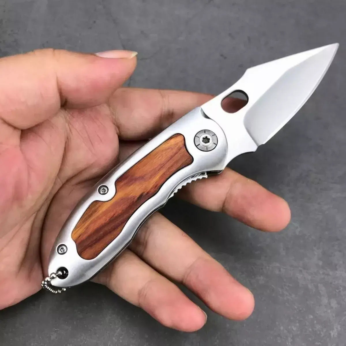 Browning F113 folding knife with silver handle and wooden inlay for outdoor use