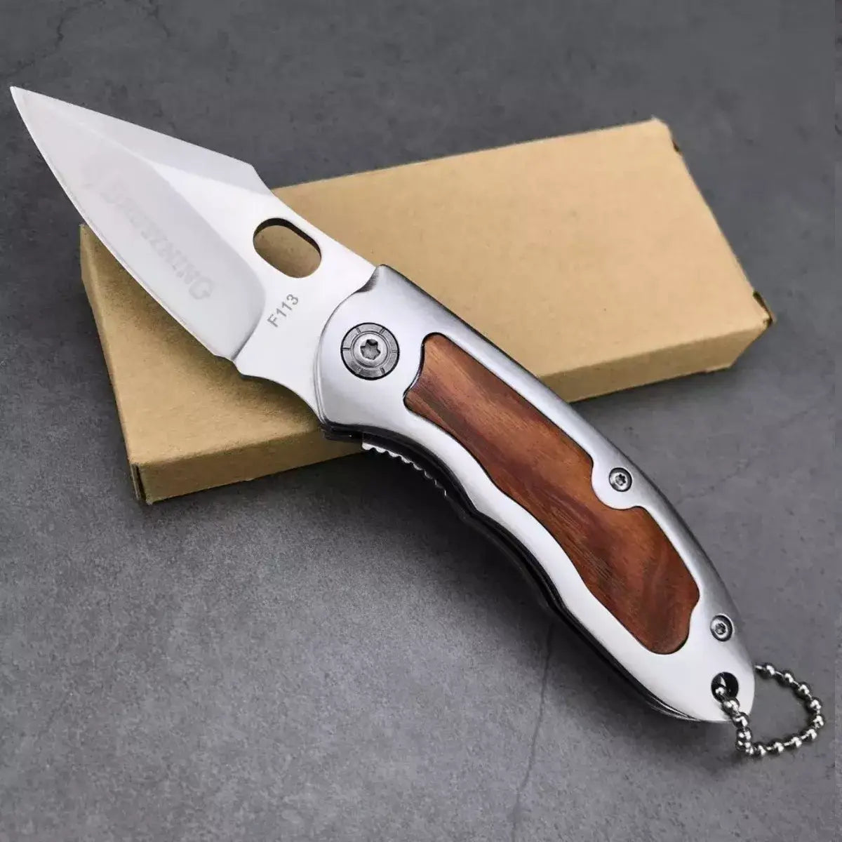 Browning F113 folding knife with silver blade and wood inlay handle for outdoor use
