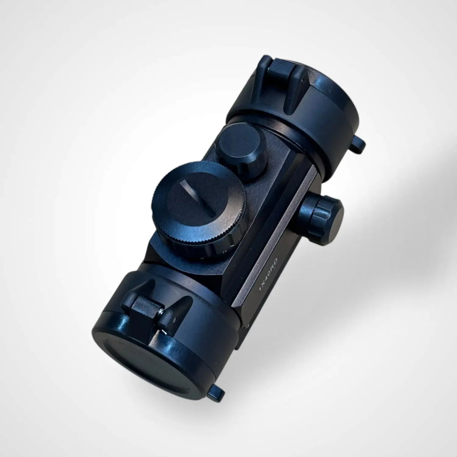 Black tactical red dot sight with adjustment knobs for precise aiming and green dot visibility