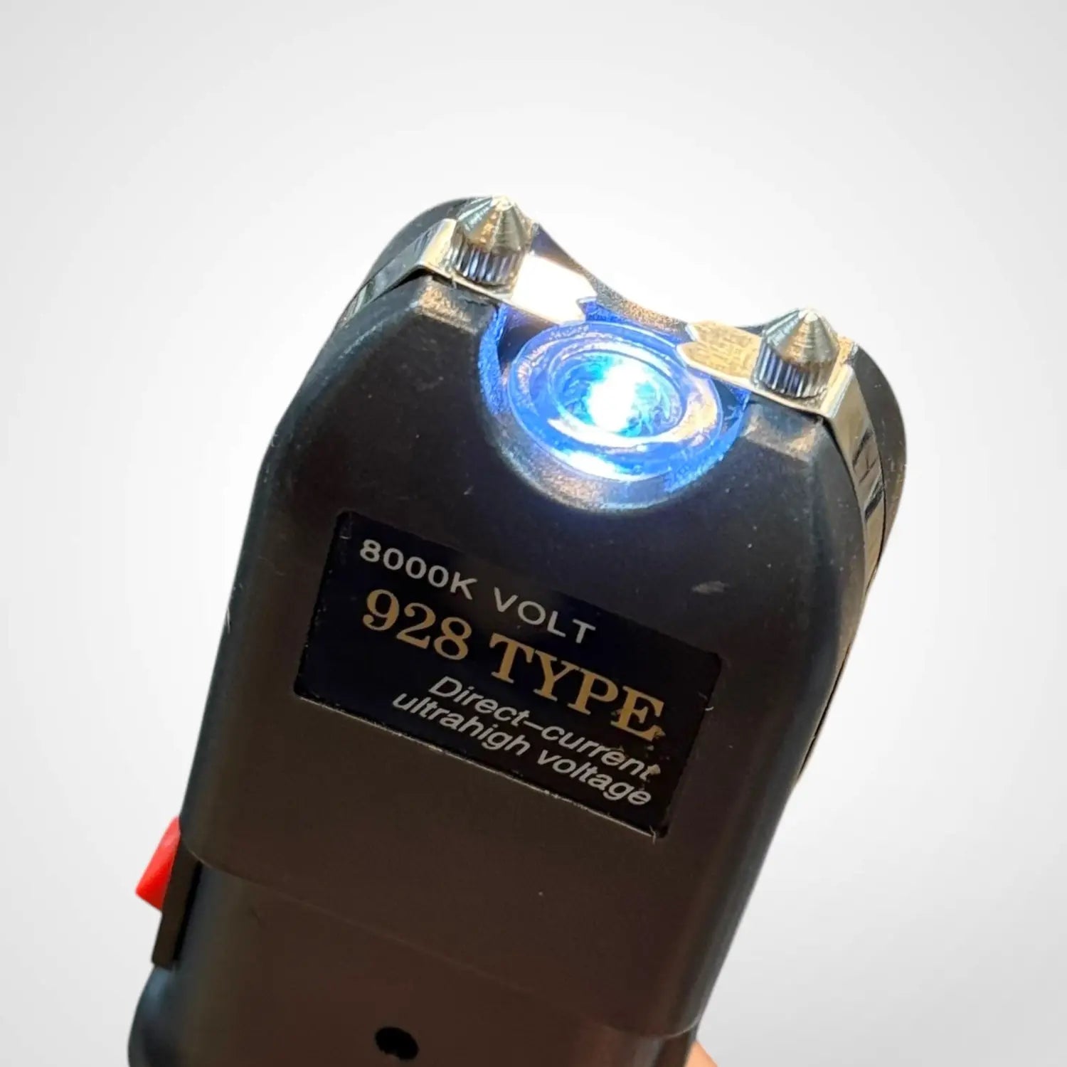 Portable Anti Riot 8000V Stun Gun with blue light and metal prongs for self-defense