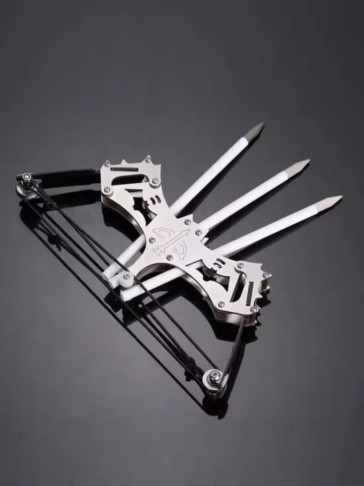 Silver-colored mini compound bow with integrated bow mechanism and three-pronged harpoon