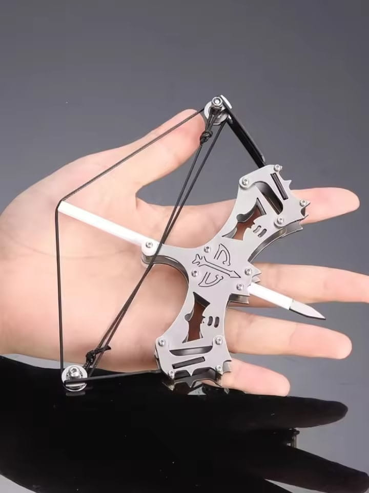 Compact metal white mini compound bow held in hand, perfect for beginners and collectors