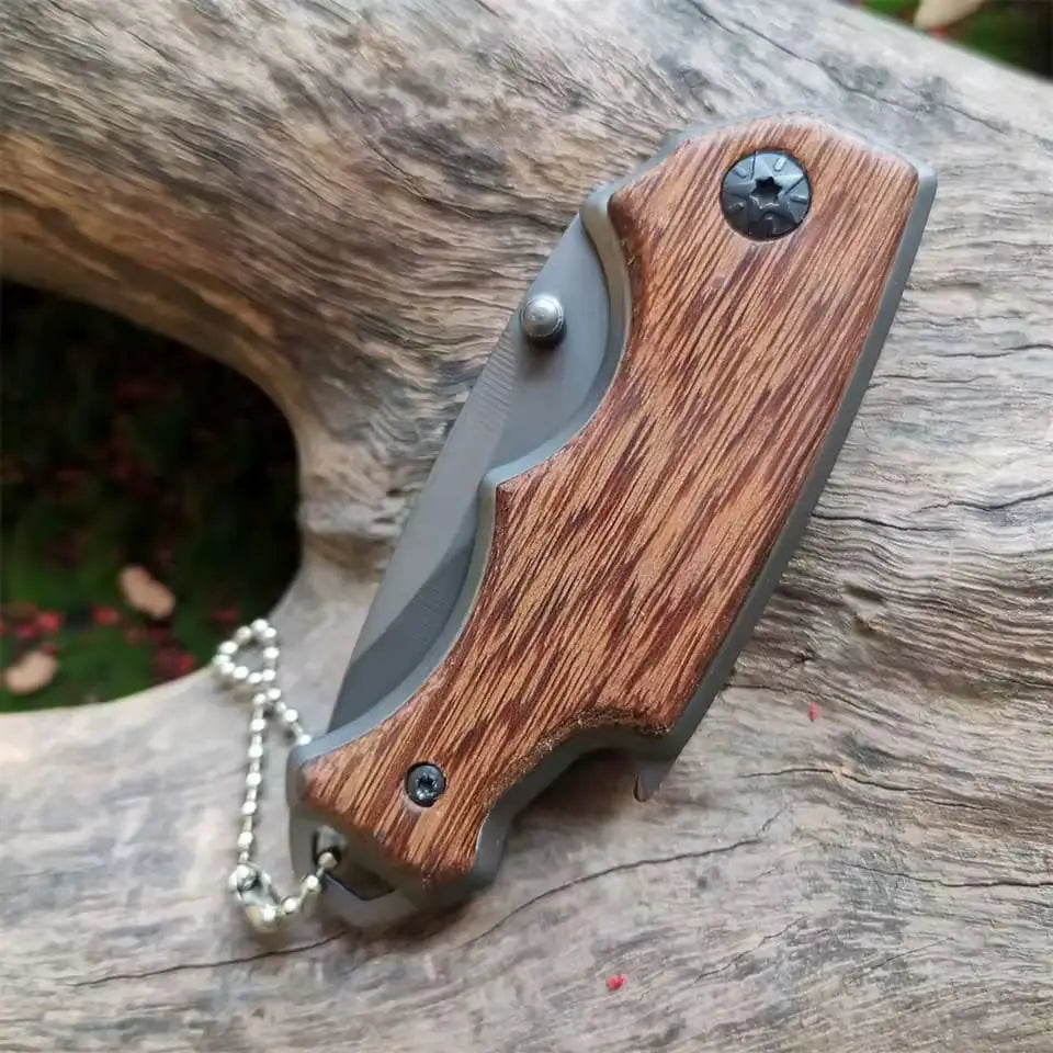 Buck X74 folding knife with gray blade and wooden handle for versatile outdoor use