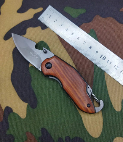 Buck X48 folding knife with wooden handle and metal ruler for versatile cutting tools