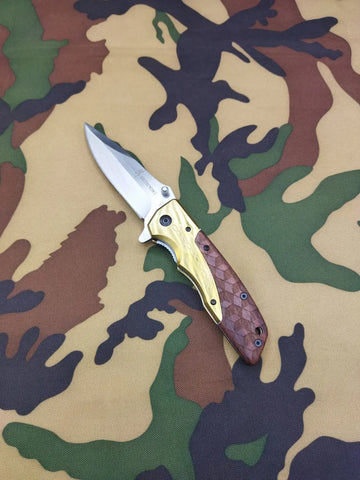 Browning DA77 Titanium Pocket Knife with silver blade and gold brown patterned handle