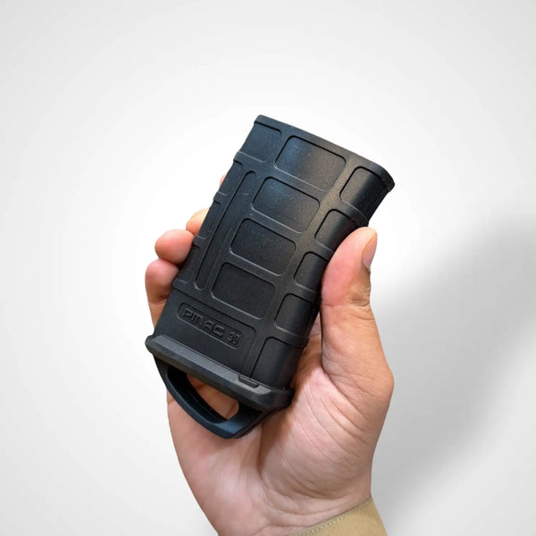 Black polymer magazine with rubber Magpul assist and integrated pull loop for tactical use