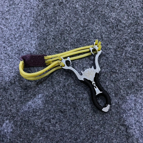 Aluminum slingshot with black ergonomic grip and yellow rubber bands for precise aiming