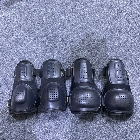 Four pairs of black knee protective pads and shin guards for tactical protective gear