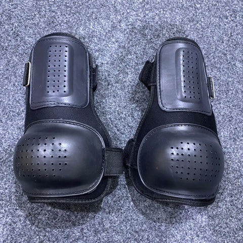 Black tactical knee protective pads with ventilation holes for added comfort and safety