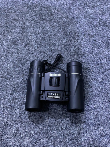 Black Bushnell 8x21 compact binoculars with neck strap for bird watching and outdoor activities