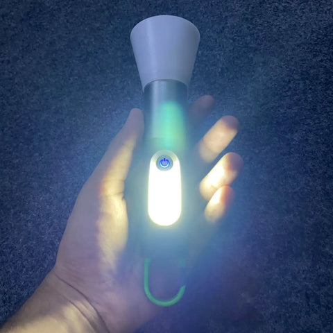 Hand holding a bright green and white GT10 Outdoor Camping Flashlight Lantern with power button
