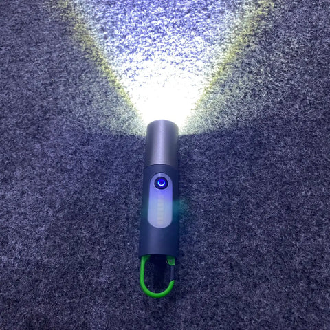 GT10 outdoor camping flashlight with bright beam, gray and blue handheld design with green carabiner clip