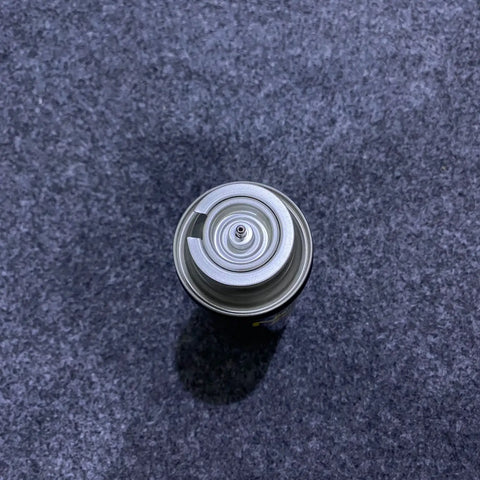Empty silver Campergas 220ml butane gas canister with valve stem for camping use