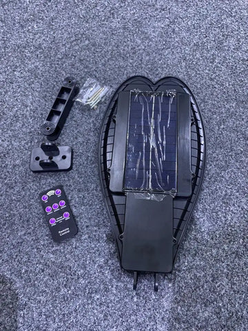 Disassembled Solar LED Motion Sensor Street Light with remote control and mounting hardware