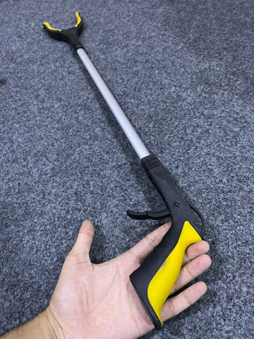 Black and yellow extended objects grabber reacher tool with long handle for easy pickup