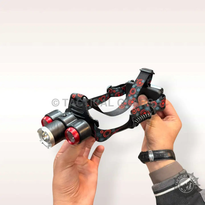 Black adjustable rechargeable headlight with main and red-rimmed side lights on elastic headband