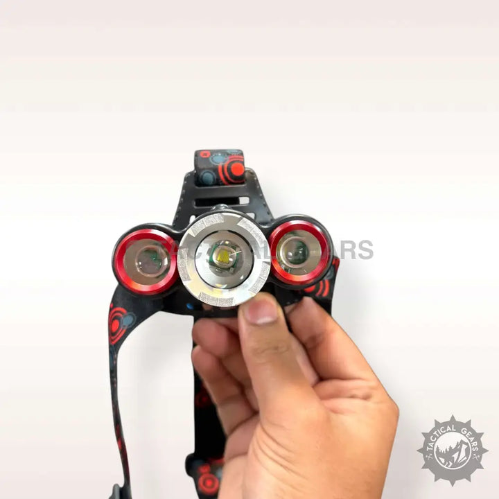 Black and red patterned adjustable rechargeable headlight with three LED lights in hand