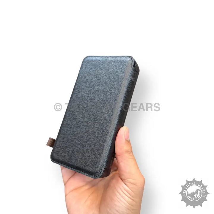 Hand holding a black faux leather solar power bank case for AIROX MP-10000 solar power bank