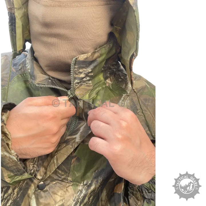 Person wearing All Purpose Men’s Camo Rain Suit with camouflage jacket and tan neck gaiter