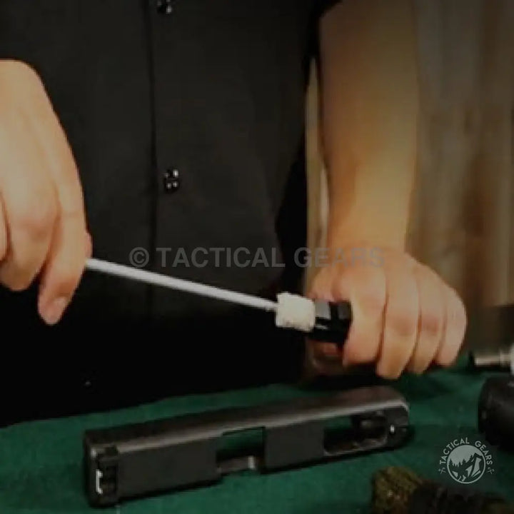 Disassembled handgun slide being cleaned with a cal brush using the Universal Cleaning Kit