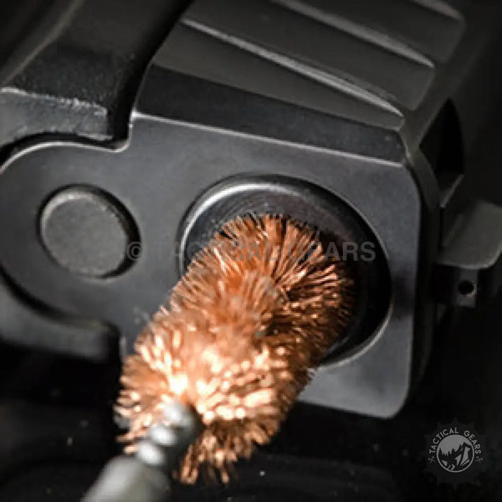 Copper-bristled bore brush cleaning firearm chamber in Universal Cleaning Kit for effective cleaning