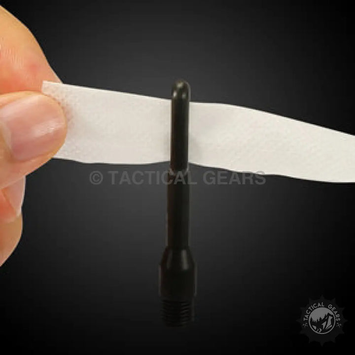 Person’s hand holding a white strip of paper with a cal brush in the Universal Cleaning Kit