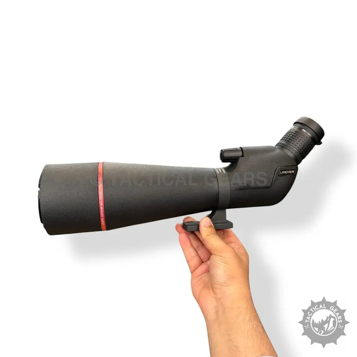 Black angled 75x80 spotting scope with phone adapter held by hand for outdoor viewing