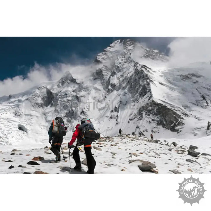 Backpackers trekking with 4mm paracord rope in snowy mountain landscape
