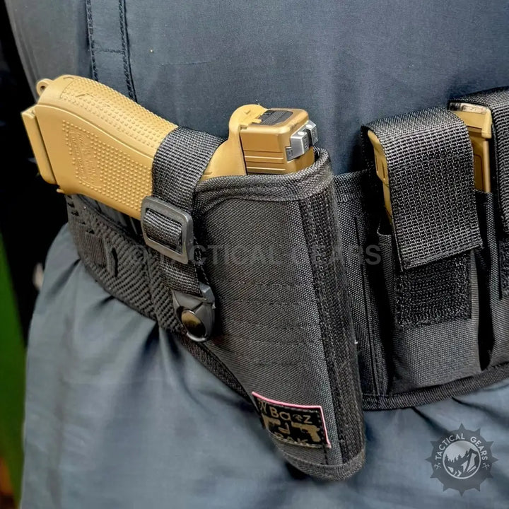 Tan handgun in a black tactical belt holster with magazine pouches on a tactical belt