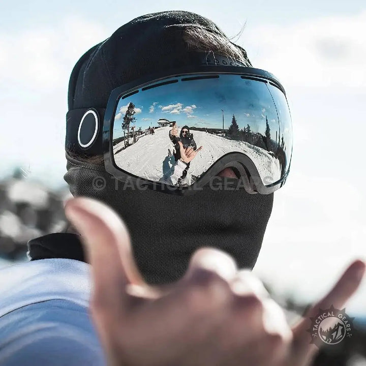 Mirrored ski goggles worn on a person’s head with a Balaclava Neck Gaiter Cap