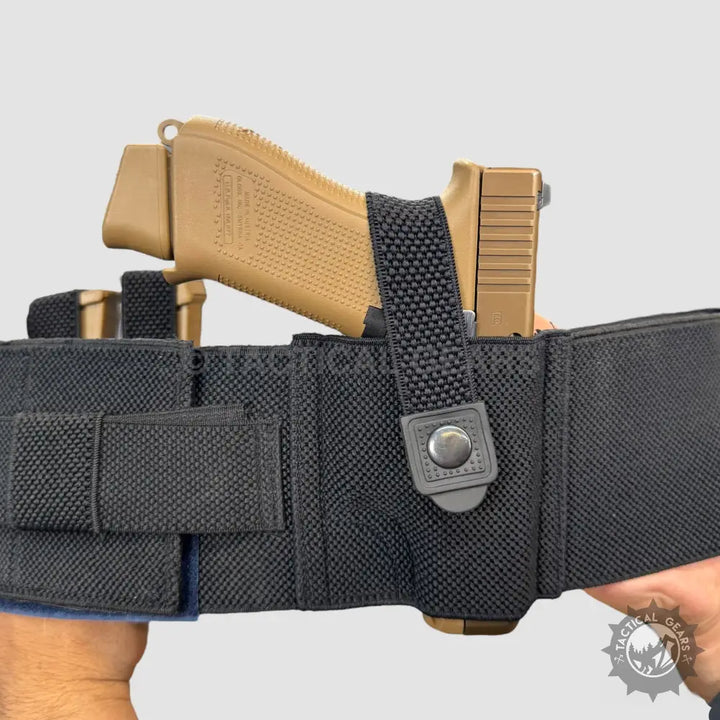 Tan handgun secured in black tactical belt with magazine pouches for concealed carry