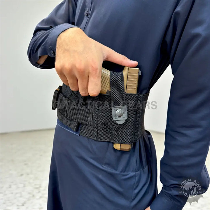 Person wearing dark blue long-sleeved shirt with belly band holster and magazine pouches for concealed carry