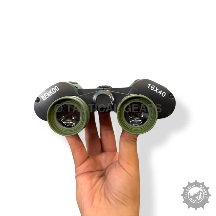 Black and olive green Benkoo 16x40 binoculars with focus wheel held in hand