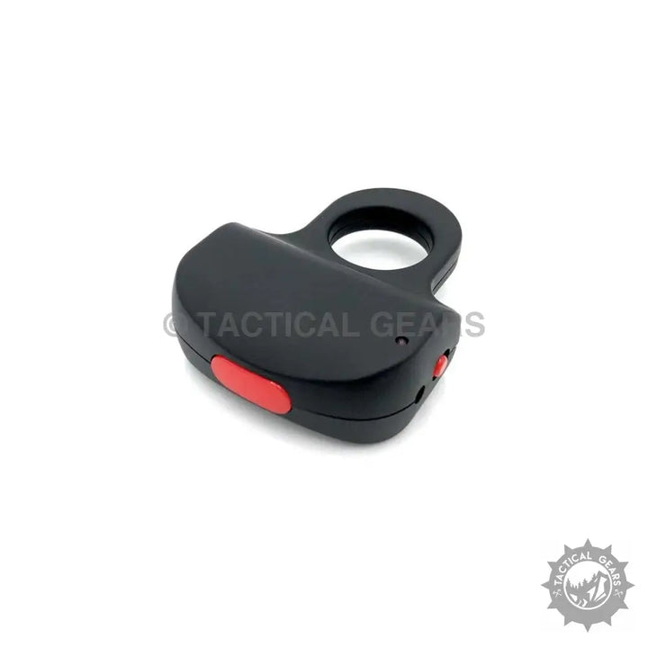 Black self-defense knuckle duster with red activation button for electric shock protection